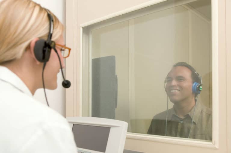Audiologist giving hearing test