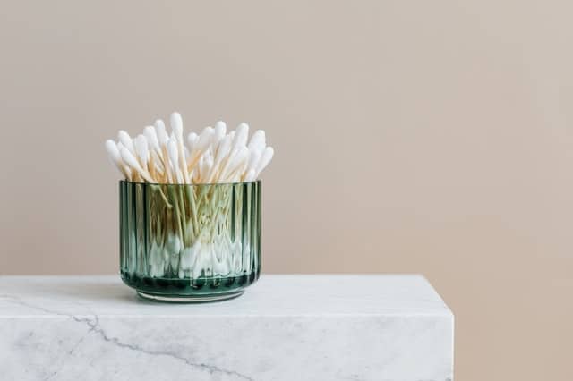 photo-of-white-cotton-buds-in-glass-container