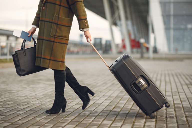 Fashionable woman carrying her bag to the airport.