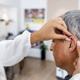 Man is fitted for hearing aids