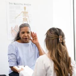 Woman discussing hearing issues with her doctor