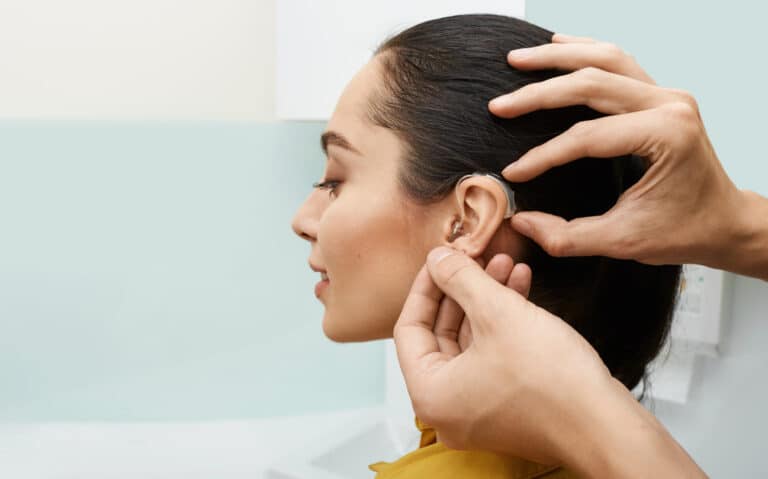 Woman getting new hearing aids fitted