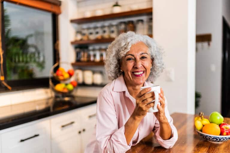 Portrait of american senior woman drinking coffee at home