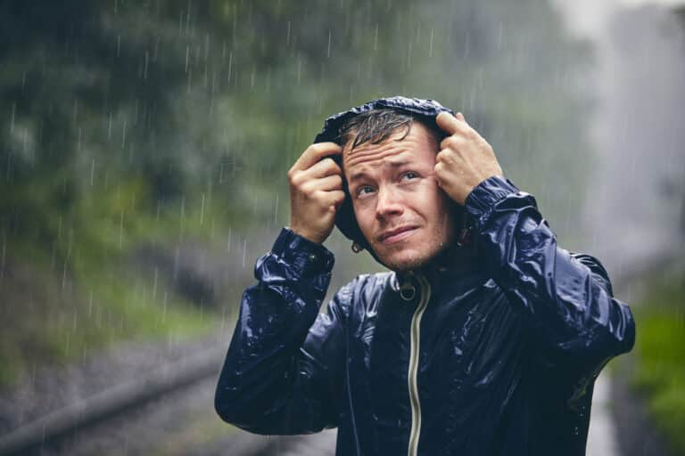 Person wearing a jacket in the pouring rain. Person wearing a jacket in the pouring rain.